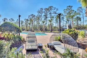 A pool area with lounge chairs and a small pool. - Upstay - LRG Condo w Outdoor Pool, Sauna (Winter Garden)