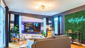 Ein modernes Wohnzimmer mit einer Couch, einem Fernseher und Dekorationselementen.
