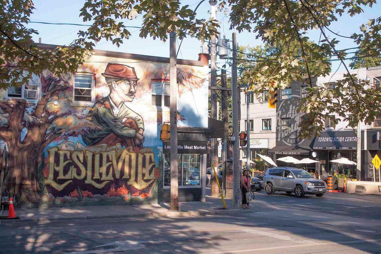 A mural on a building with a tree and the word 'LESIEVILLE' visible.