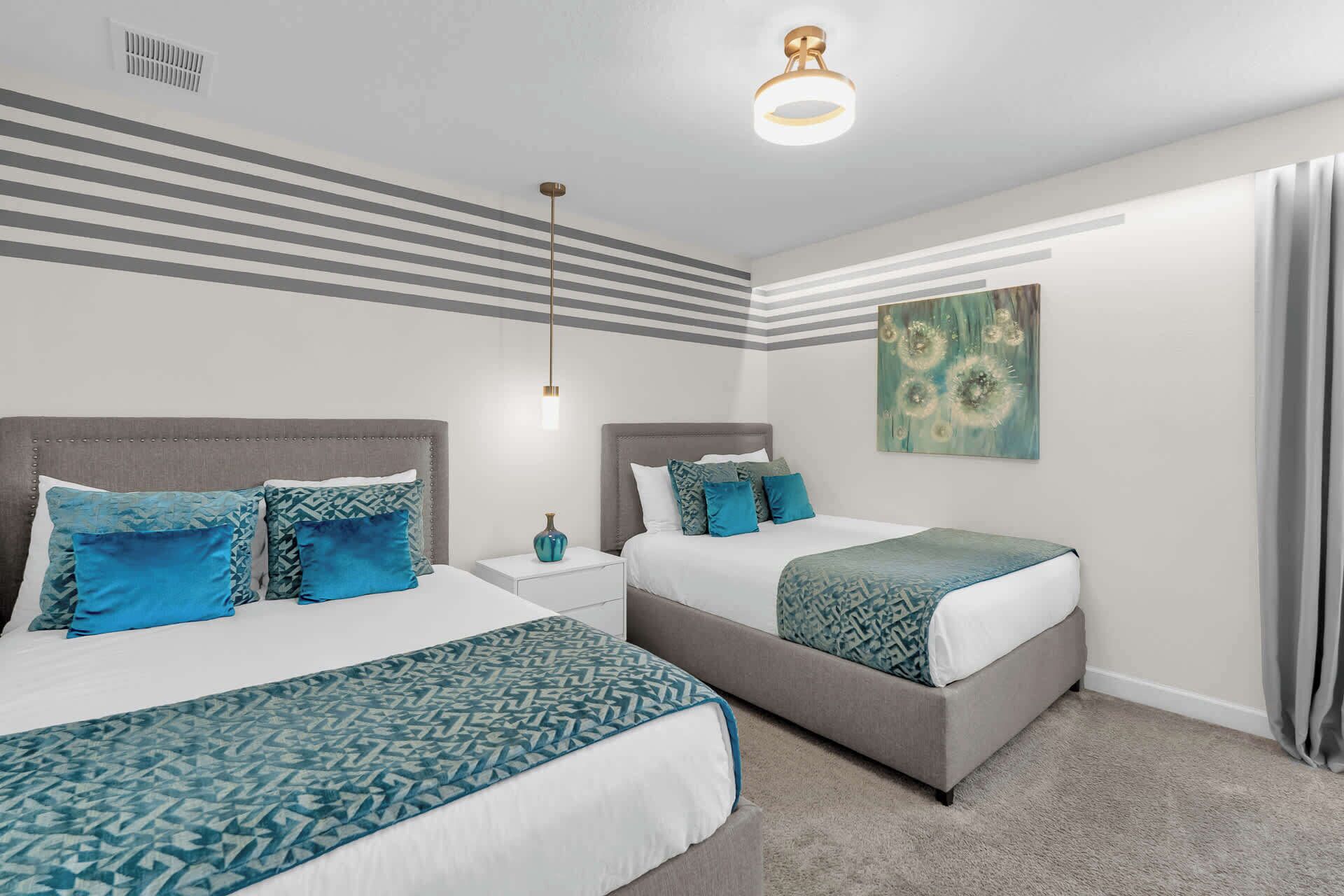 A modern bedroom with two beds, a nightstand, and a ceiling light fixture.
