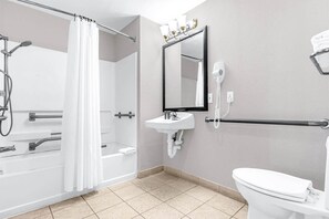 A bathroom with a shower, a sink, a toilet, and a mirror. - Near Disney King Bed Condo Unit - Pool & Hot Tub! (Orlando)