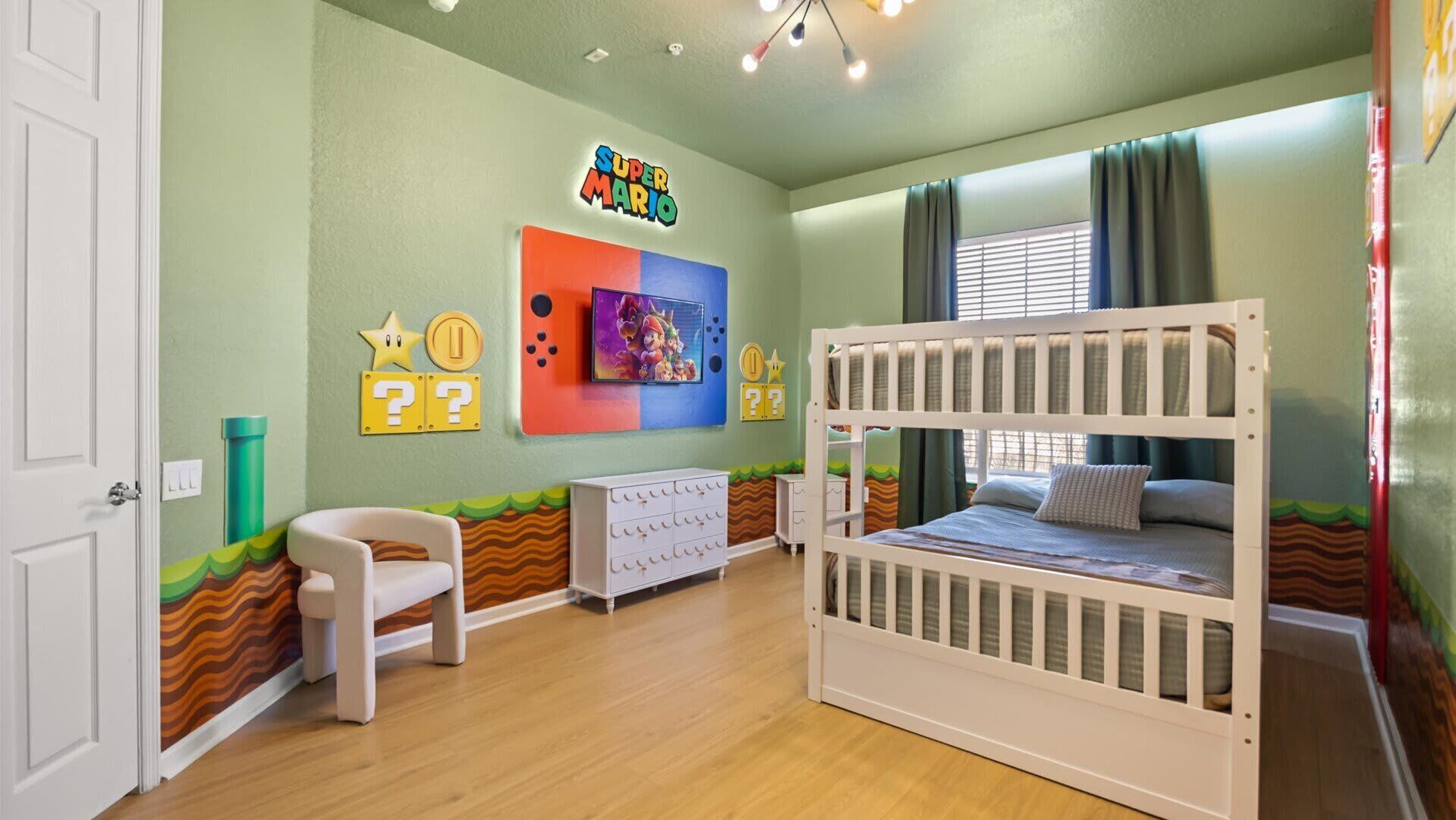 A child's room with a bunk bed, a desk, and a chair.