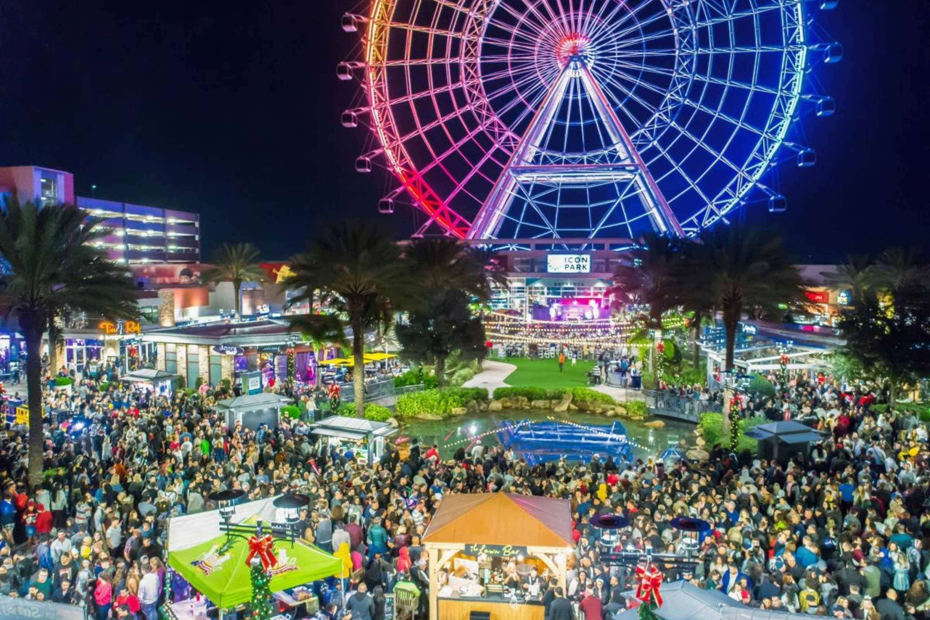 Ein großes Open-Air-Event mit Riesenrad und vielen Besuchern.