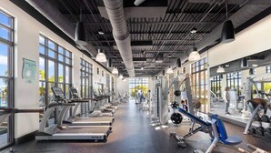 A gym with treadmills, weight machines, and free weights. - Solara Resort Home With Private Pool Near Disney (Kissimmee)