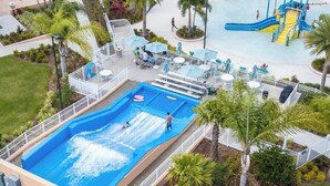 A water park with multiple slides and a wave pool. - Solara Resort Home With Private Pool Near Disney (Kissimmee)