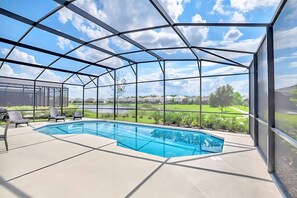 A covered outdoor swimming pool with a clear view of the surrounding landscape. - Upstay Lakefront Home w Pool Cinema, Games, BBQ (Kissimmee)