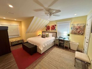 A bedroom with a bed, bedside table, chair, and a radiator. - Canal Front Retreat w/ Boat Dock & Coastal Views (Port Isabel)