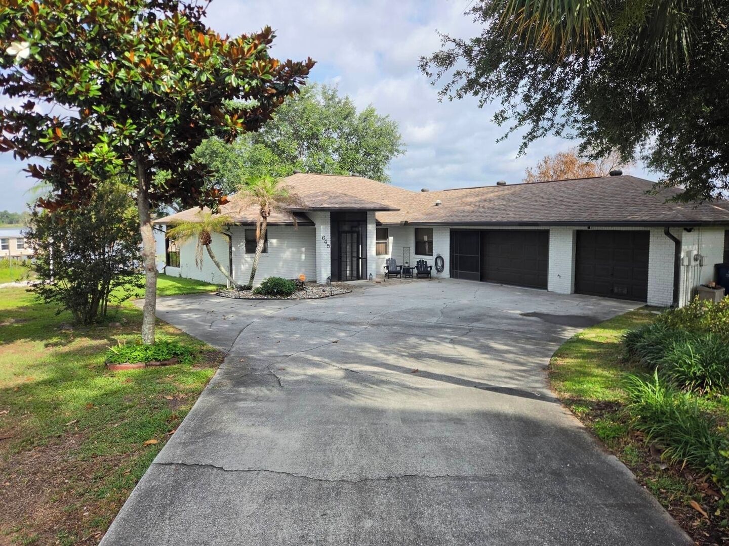 A single-story house with a driveway leading to a garage.