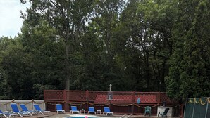 A swimming pool with lounge chairs and inflatable toys. - RV-accessible cozy private campground with pool access near Lake Wallenpaupack (Hawley)
