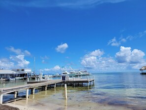 A marina with boats docked, a pier, and a small building labeled "MAR". - Reef Haven Penthouse | 1BR Sea View Suite (San Pedro)