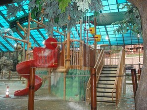 A water play area with a red slide and stairs leading up to it. - 4th July Westgate Smoky Mtn with heated indoor water park free (Gatlinburg)
