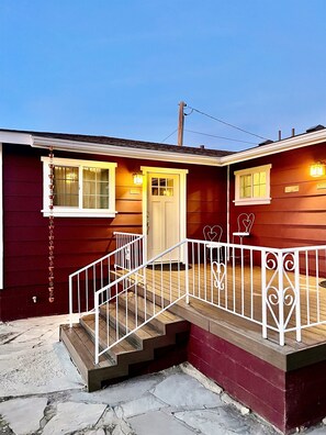A two-story house with a front porch, a staircase, and a garage. - The Whiskey Row Bungalows - Steps to Downtown! (Prescott)