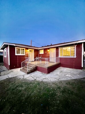 A two-story house with a front porch, a staircase, and a garage. - The Whiskey Row Bungalows - Steps to Downtown! (Prescott)
