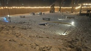A snow-covered outdoor area with seating and string lights. - 1mi to Downtown |Hot Tub - Fenced Yard - Game Room (Waynesville)