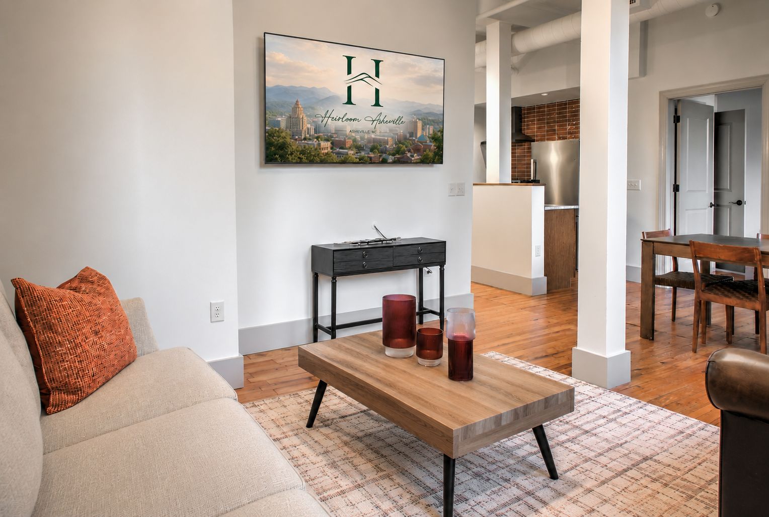 Een moderne woonkamer met een bank, salontafel en een stadsgezicht aan de muur.