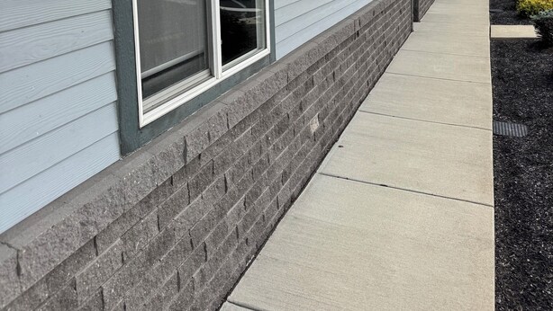 A building with a long, straight facade, large windows with metal frames, and a brick base. - The Modern Point- 5 nearby Cedarsports&Cedarpoint (Sandusky)