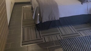 A bedroom with a bed, a ceiling fan, and a patterned floor. - The Modern Point- 5 nearby Cedarsports&Cedarpoint (Sandusky)