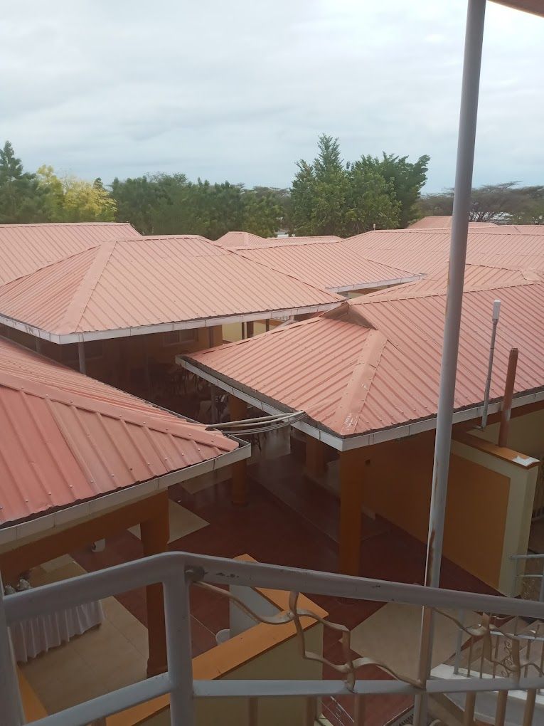 A building with multiple red-roofed structures, likely part of a hotel or residential complex.