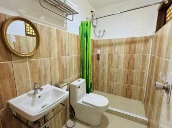 A bathroom with a shower, toilet, and sink. - Almost Heaven Lake Resort (Cavinti)