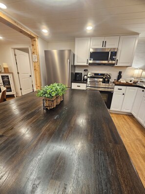 Bright modern kitchen with large island and stainless steel appliances