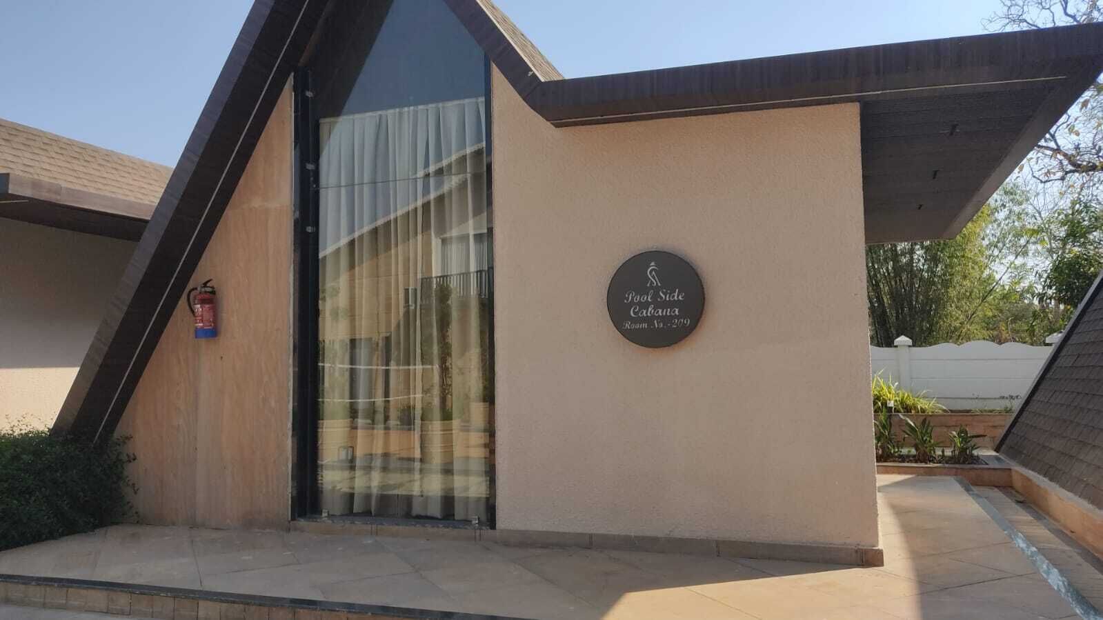 A building with a sign indicating 'Pool Side Cabana Room No. 279'.