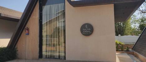 A building with a sign indicating 'Pool Side Cabana Room No. 279'.