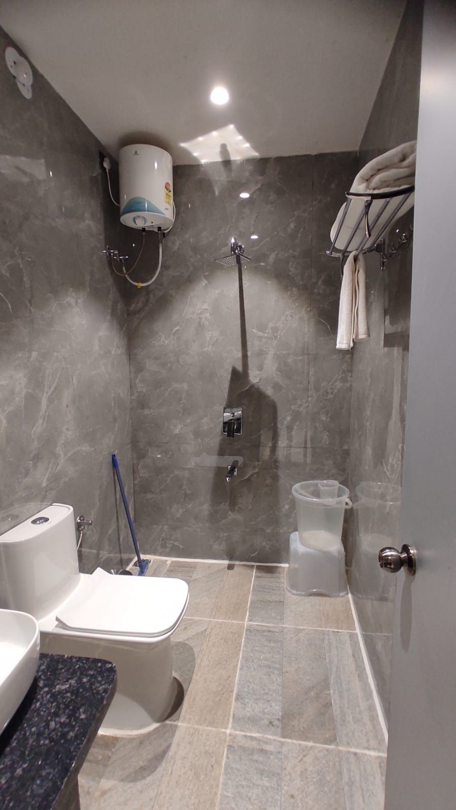 A bathroom with a shower, toilet, and sink.
