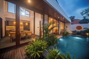 A modern house with a pool, wooden deck, and indoor dining area. - Brand New 2Bedroom Water Lily Villa Private Pool (Denpasar Selatan Bali)
