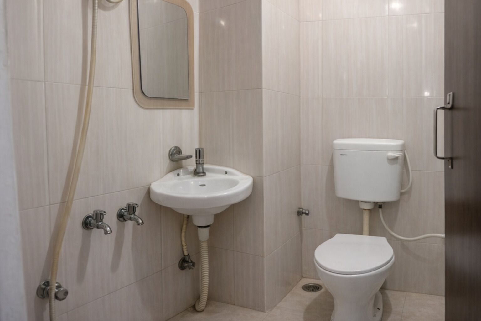A bathroom with a white sink, a toilet, and a shower.