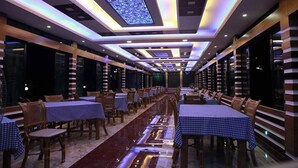 A spacious dining area with tables and chairs, a long corridor, and a modern ceiling design. - Venus Resort Bandarban (Bandarban)