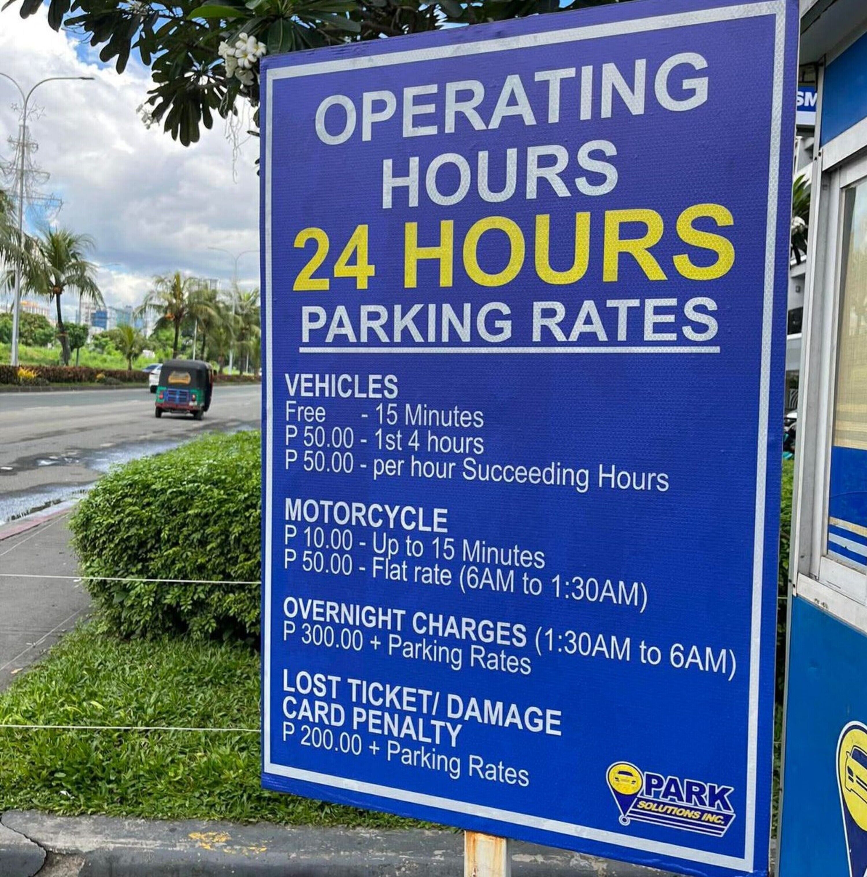 A parking sign detailing operating hours and parking rates.