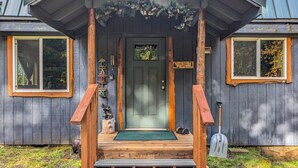 A cabin with a wooden porch, a green door, and a sign that reads "Cabin". - Fir Tree Cabin | Grill, Fireplace (Packwood)