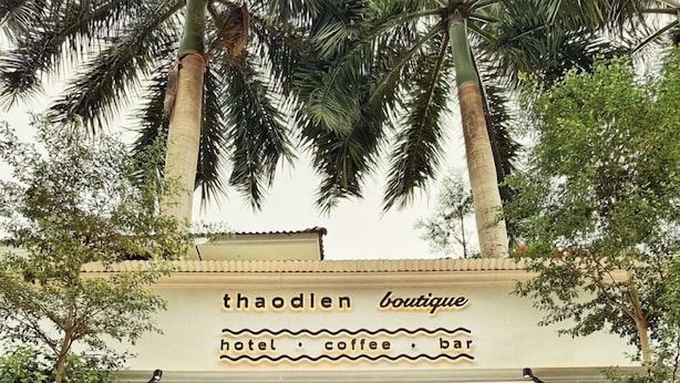 A boutique hotel entrance with a sign reading "thaooden boutique hotel, coffee bar." - ThaoDien Boutique Hotel (Ho Chi Minh City)