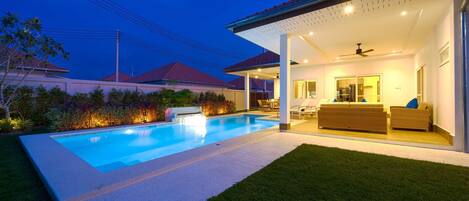 Alberca al aire libre y camastros