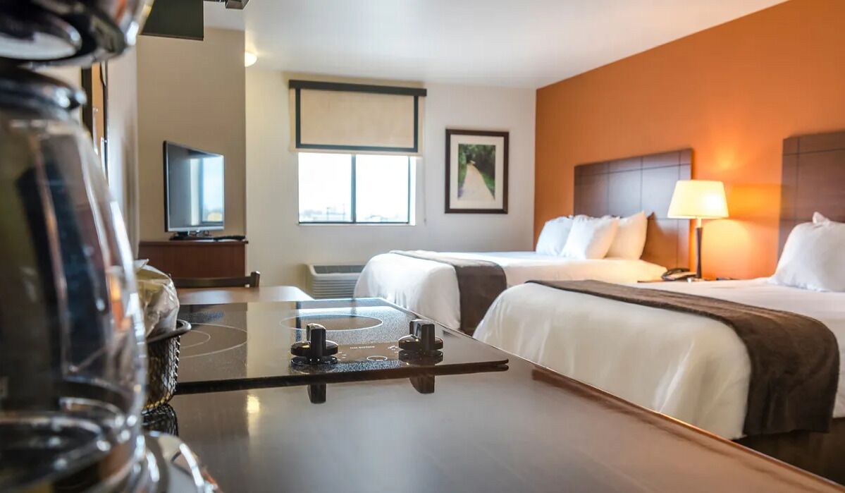Settle in with an easy kitchenette setup beside plush beds.