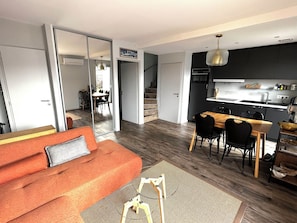 A modern apartment with a living room, dining area, and kitchen. - A pearl between lake and mountain (Veyrier-du-Lac)