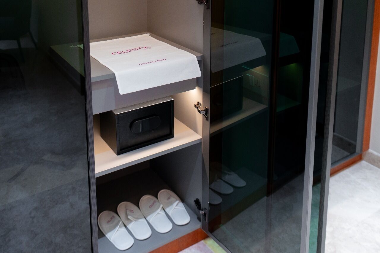 A shoe display with a white cloth and a black box.