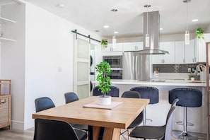 A modern kitchen with stainless steel appliances, a central island, and pendant lighting. - 3-bedroom house in fabulous Las Vegas (Las Vegas)