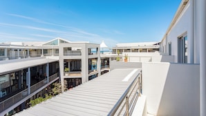 A modern building with multiple balconies and large windows, likely part of a hotel or office complex. - Seaside Village J9 by CTHA (Cape Town)