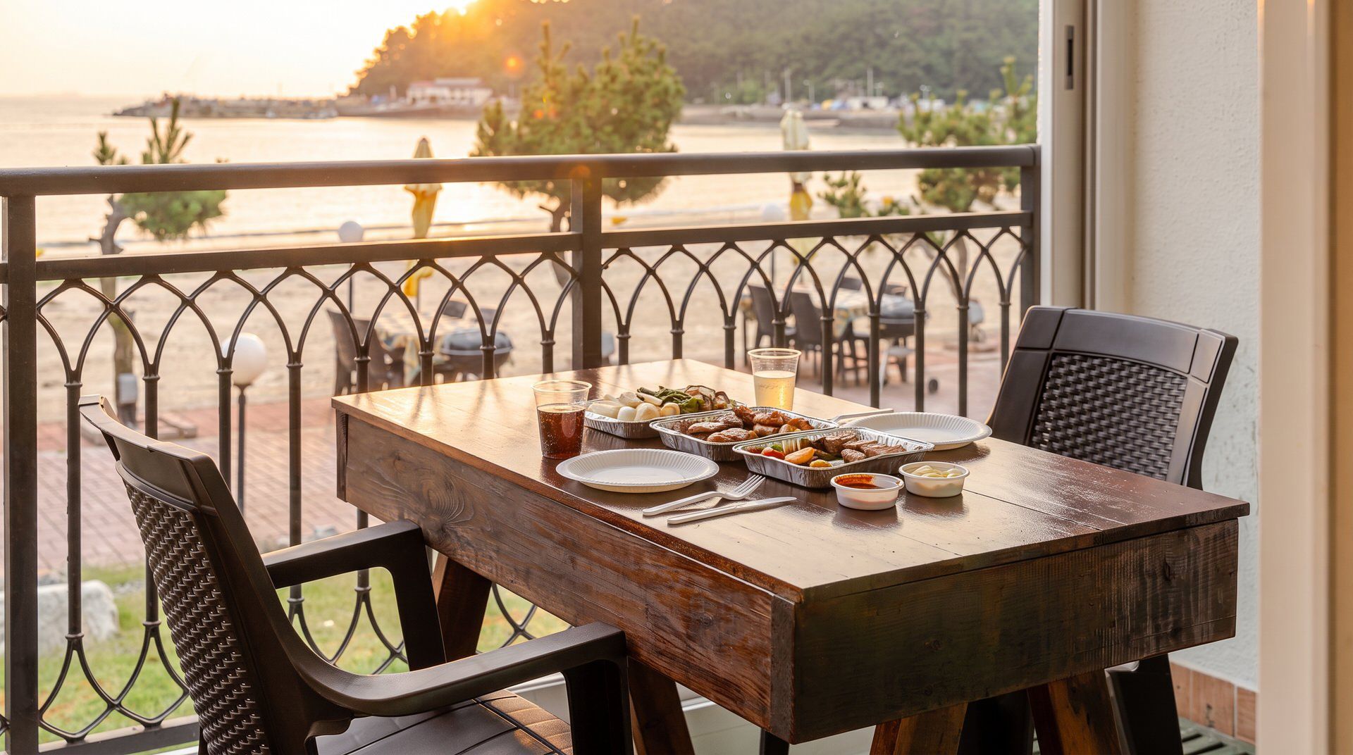 A wooden table with a view of a body of water, a railing, and outdoor seating.