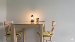 A table with two chairs, a lantern, and a small plant. - The Seaside Taean (Taean)