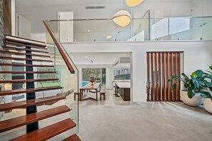 Ein modernes Interieur mit Treppe, Essbereich und Küche.