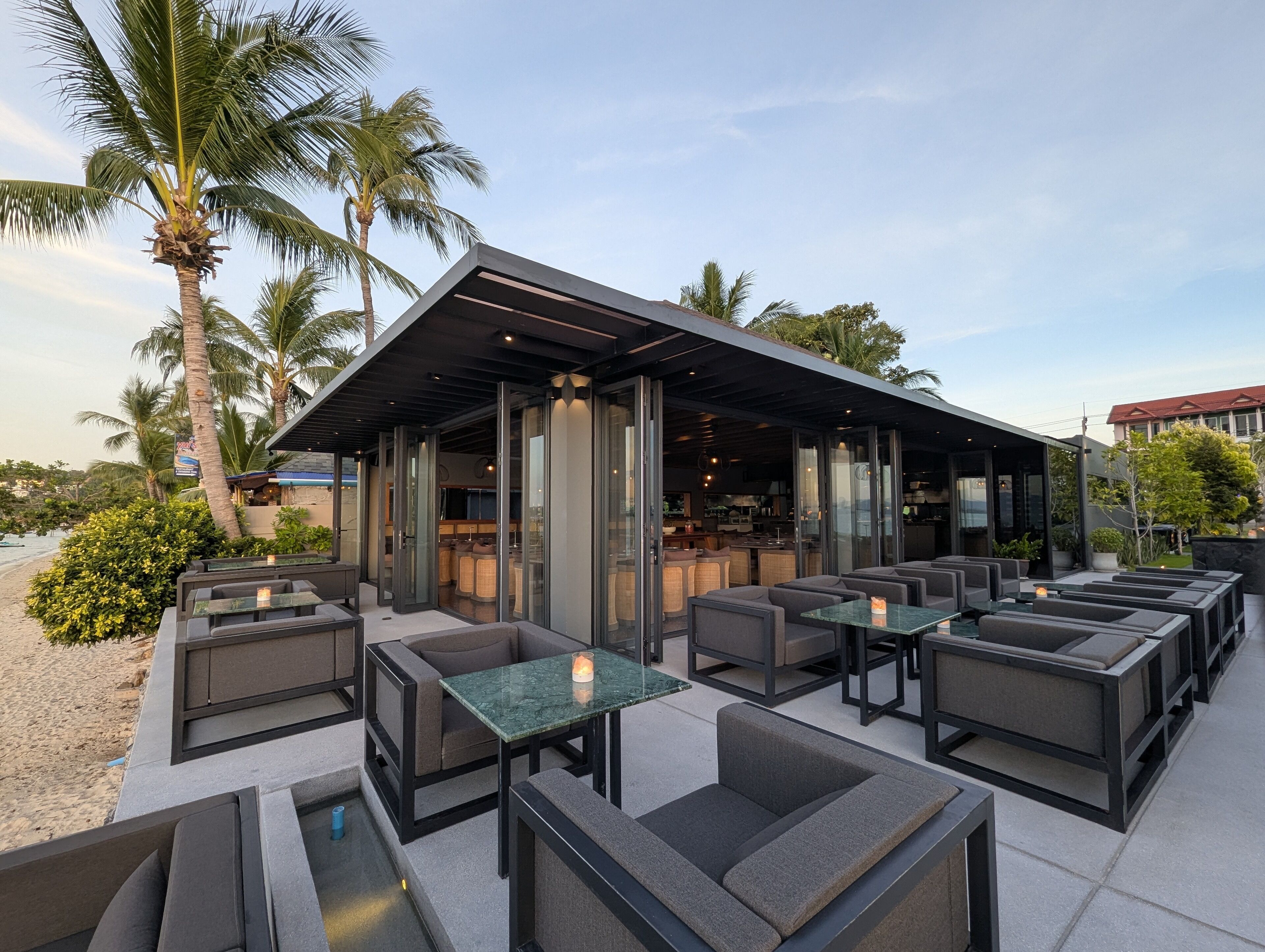 An outdoor seating area with modern furniture and a covered bar area.