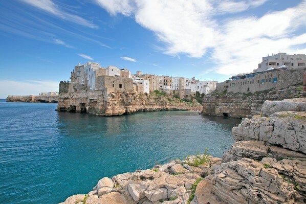 A coastal town with buildings built on rocky cliffs overlooking the sea.