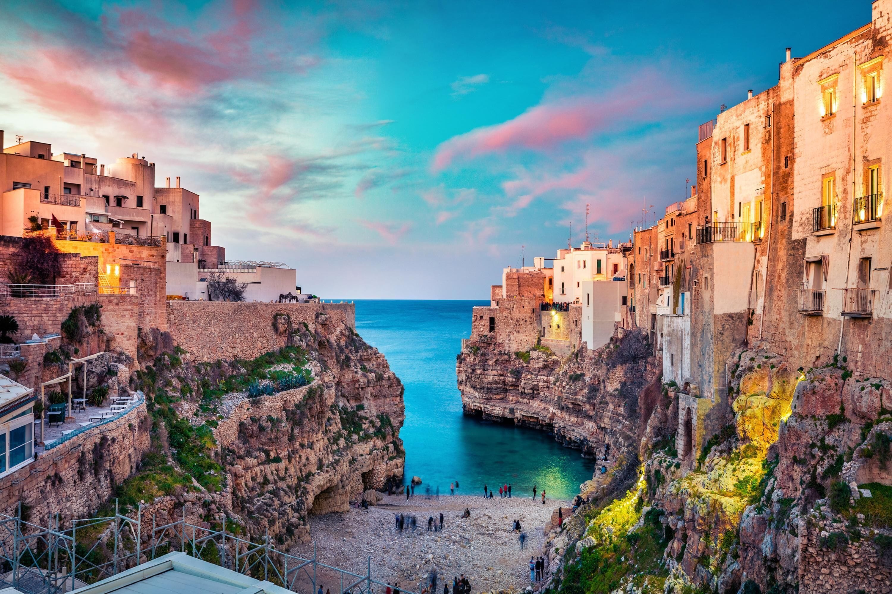 A coastal town with buildings built into cliffs overlooking the sea.