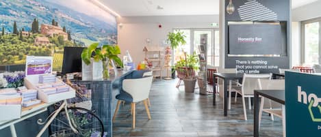 A modern interior with a bar area, seating, and a scenic mural.