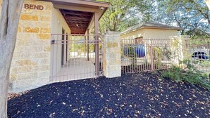 A gated entrance with a stone wall, a covered porch, and a building labeled 'BEND.' - 3-bedroom house in fabulous Helotes with AC (Helotes)