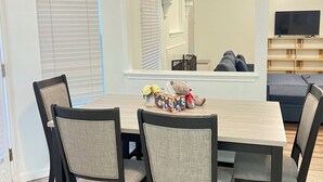 A dining area with a table, chairs, and a teddy bear on the table. - 3-bedroom house in fabulous Helotes with AC (Helotes)