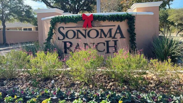 A sign with 'SONOMA RANCH' written on it, surrounded by greenery and rocks. - 3-bedroom house in fabulous Helotes with AC (Helotes)