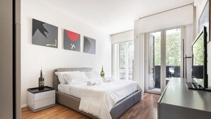 Een moderne slaapkamer met een bed, nachtkastjes en kunst aan de muur.